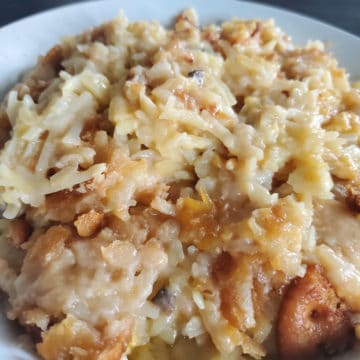 crockpot cheesy hashbrowns on a white plate