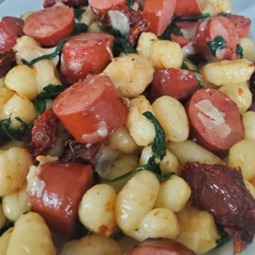 Smoked Sausage Gnocchi with Sun-Dried Tomatoes on a white plate