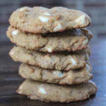 Stack of White Chocolate Pumpkin Spice Cookies on a wood board