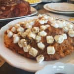 sweet potato casserole with mini marshmallows in a white bowl