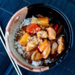 crockpot teriyaki chicken in a bowl next to chop sticks