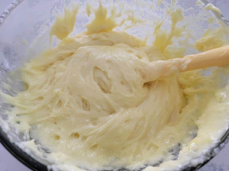 Lemon bars with cake mix batter in a glass bowl