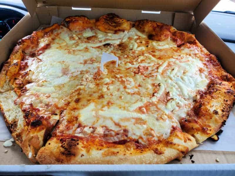 Cheese pizza in a cardboard delivery box