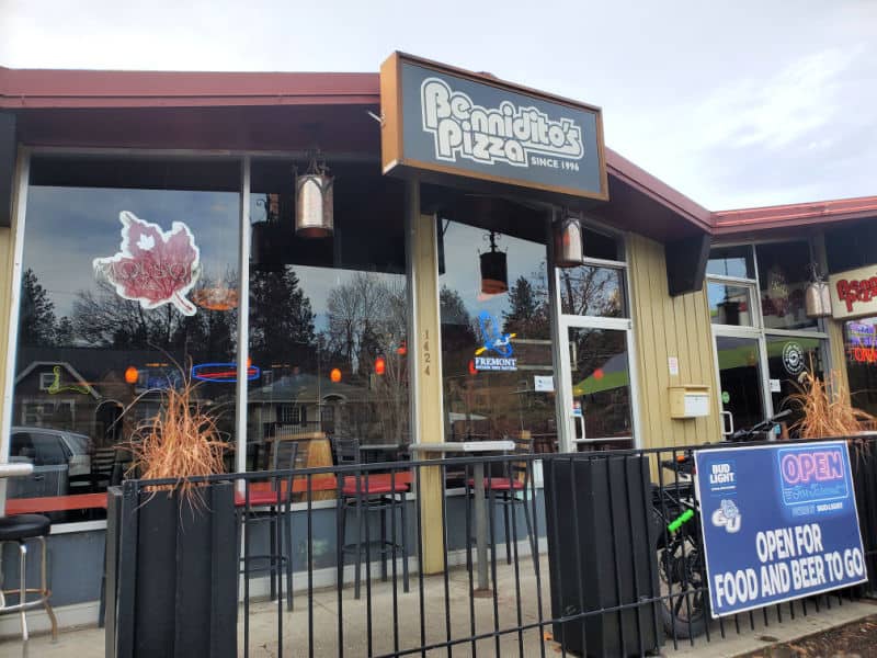 Exterior of Benniditos Pizza with glass windows and a fence leading to the door