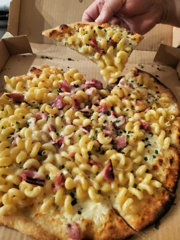 mac and cheese and bacon on a pizza in a delivery box