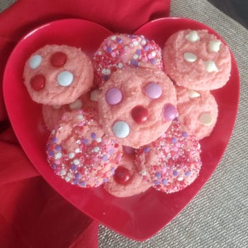Strawberry cake mix cookies on a red heart plate