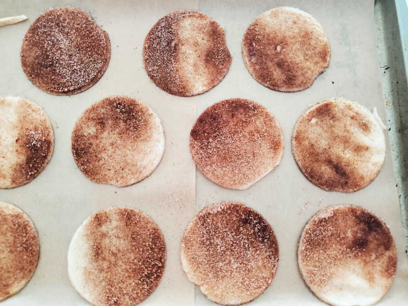 Pie crust cookies spread on a baking sheet