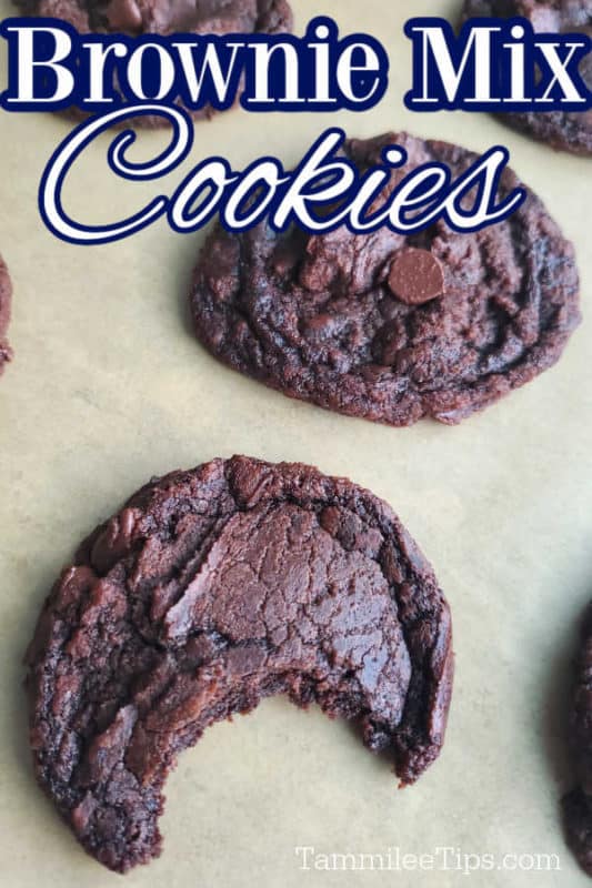 Brownie Mix Cookies text over a parchment lined sheet with cookies with one having a bite out of it