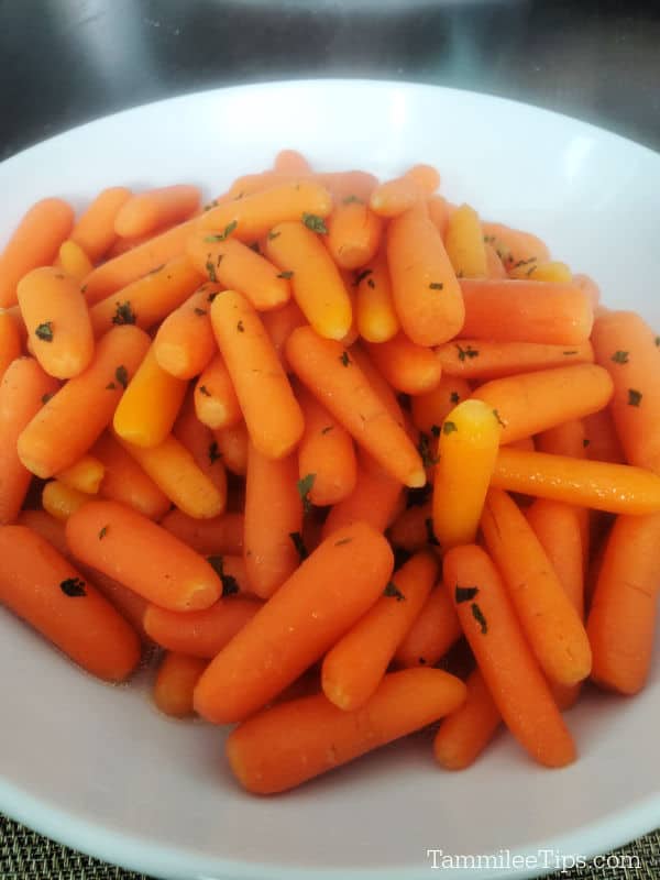 cracker barrel carrots in a white serving dish on a dark table