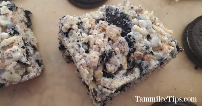 Square Oreo Rice Krispie Treat on parchment paper with Oreo Cookies