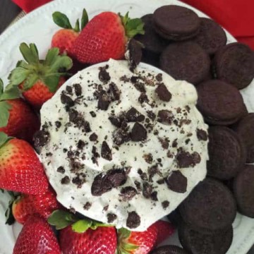 Oreo Fluff text over a bowl of Oreo Fluff Salad with strawberries and oreo cookies