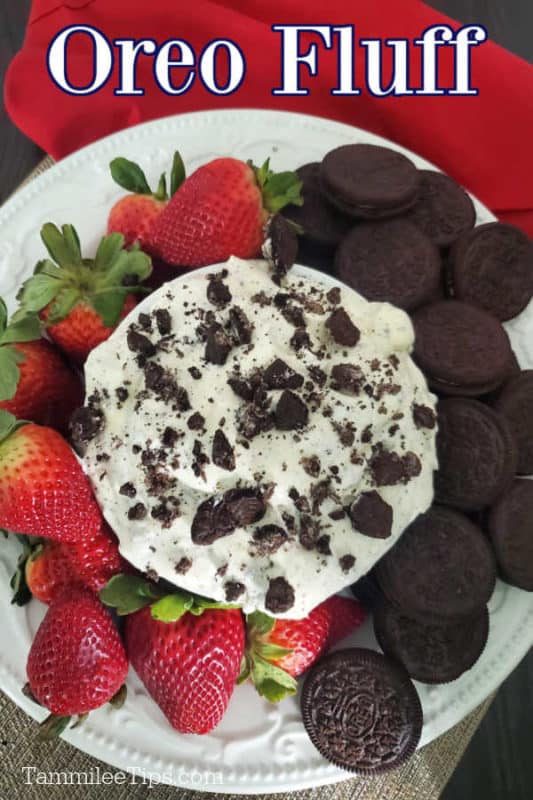 Oreo Fluff text over a bowl of Oreo Cookie Salad on a white plate with strawberries and Oreo Cookies