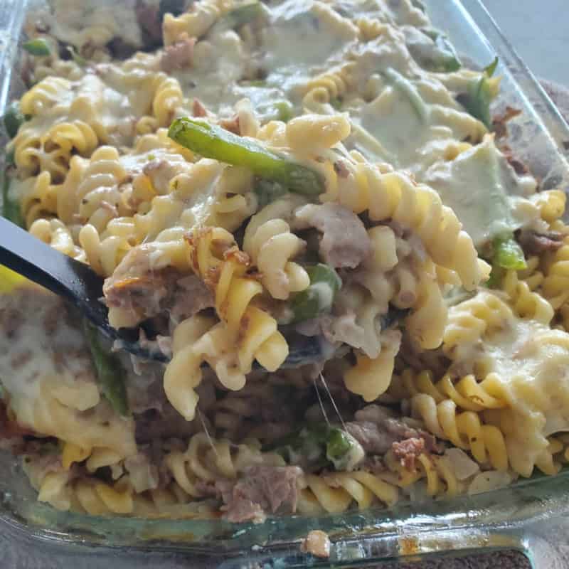 Philly cheesesteak casserole in a glass baking dish