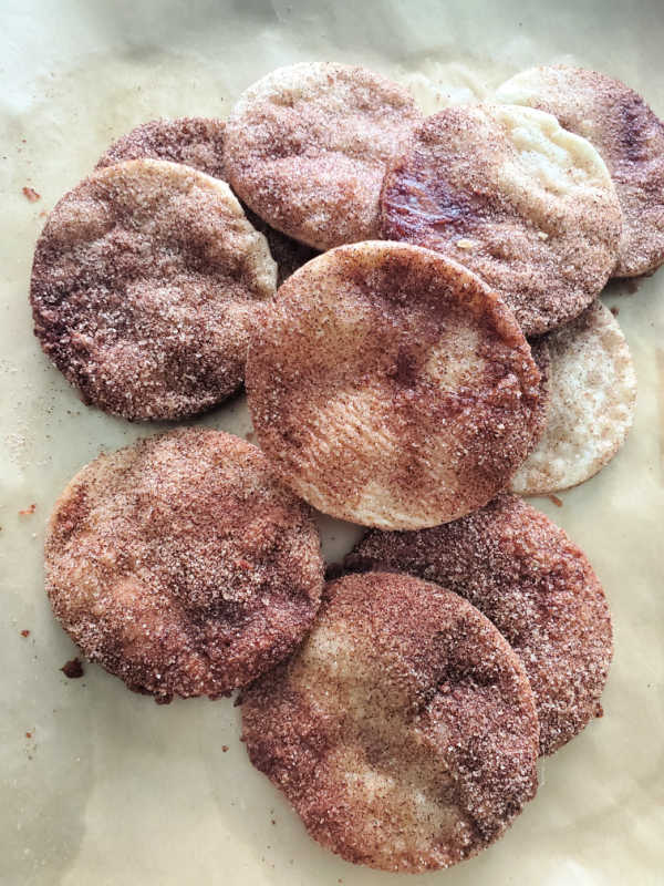 Pie crust cookies spread on parchment paper