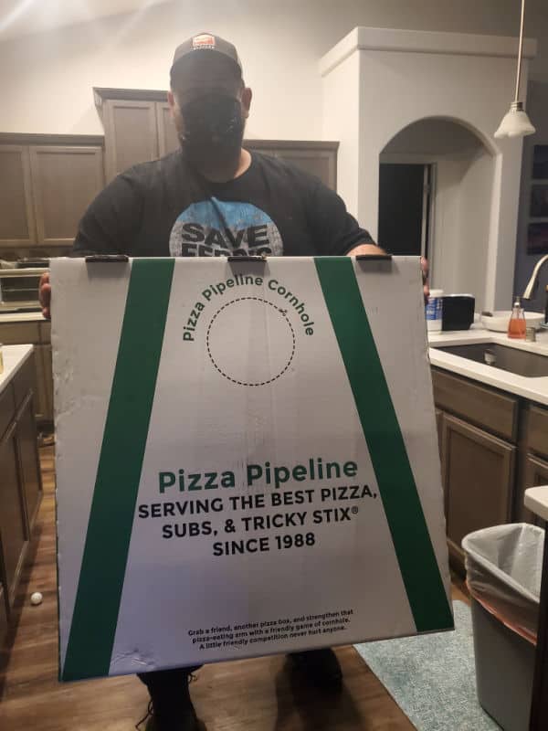 John holding a giant pizza pipeline box