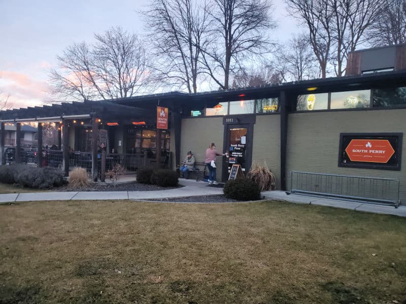 Exterior of South Perry Pizza with walkway to the front door and green lawn