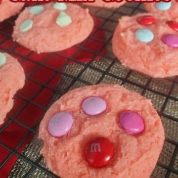 Strawberry Cake Mix Cookies text printed over pink cookies on a wire rack