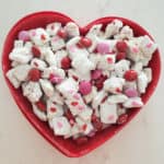 Valentine's Day Muddy Buddies in a red heart bowl