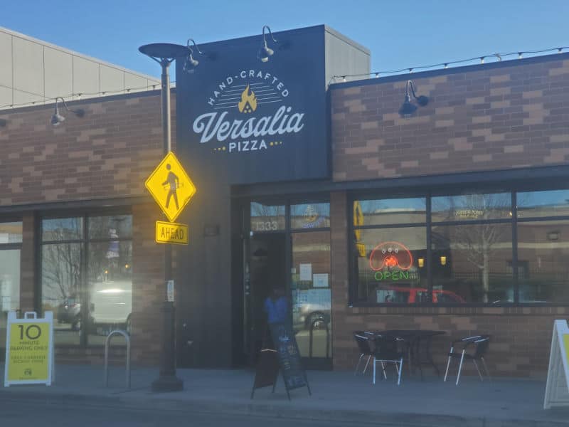 Versalia pizza restaurant exterior with tables and chairs outside