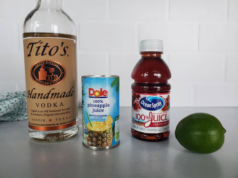 Bay Breeze Drink ingredients, Titos Vodka, Pineapple Juice, Cranberry Juice, and a lime