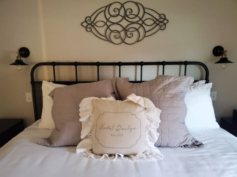 Hotel Roslyn guest bed with wrought iron frame, and Hotel Roslyn Pillow