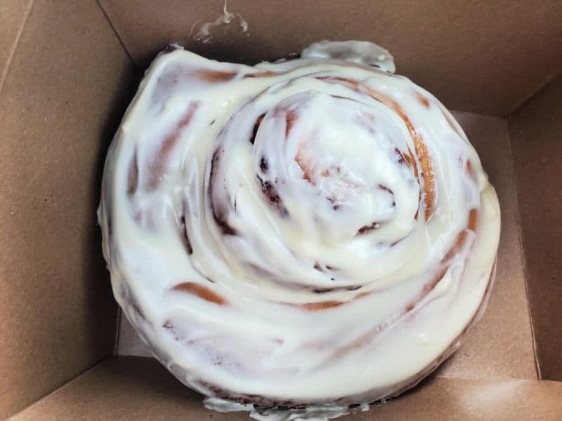 Giant cinnamon roll in brown cardboard box from Books and Bites Roslyn