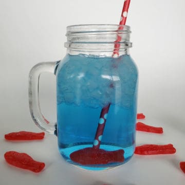 Sonic ocean water in a mason jar with a Swedish fish candy and red straw