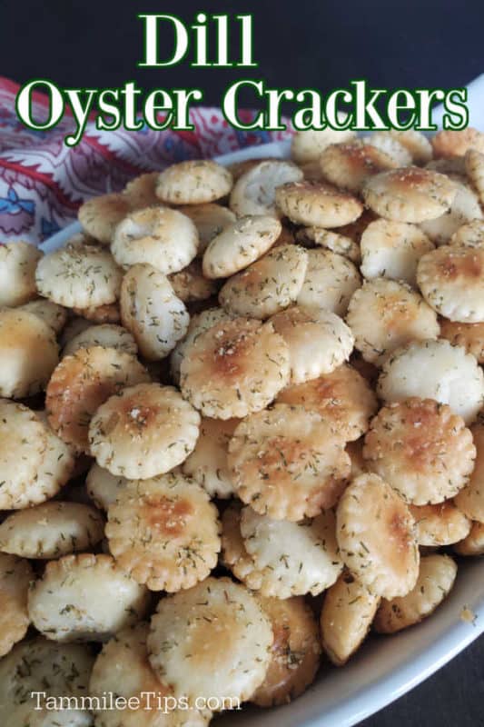 Dill Oyster Crackers over a white bowl filled with dill oyster crackers