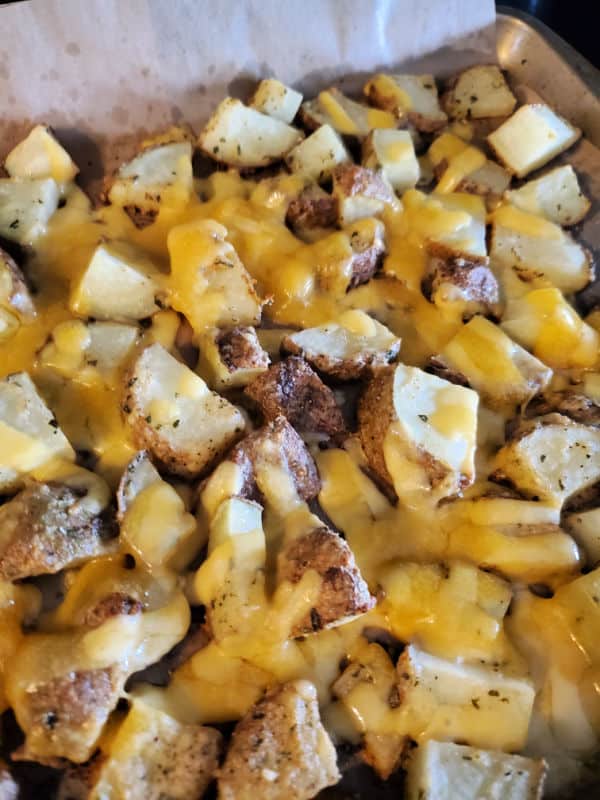 Cheesy ranch potatoes on a baking sheet out of the oven. 