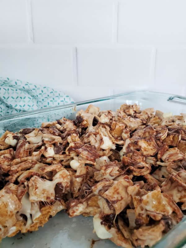 Golden Grahams Smores Bars in a baking dish with a square cut out