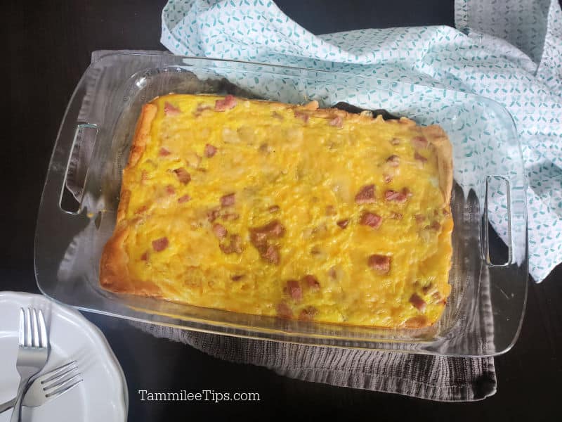 ham and egg crescent roll in a baking dish next to a cloth napkin 