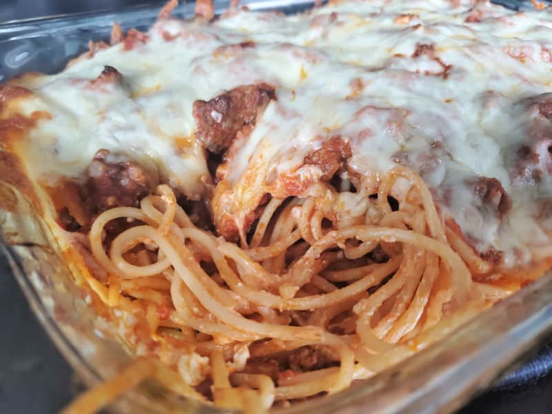 close up of million dollar spaghetti casserole in a glass baking dish