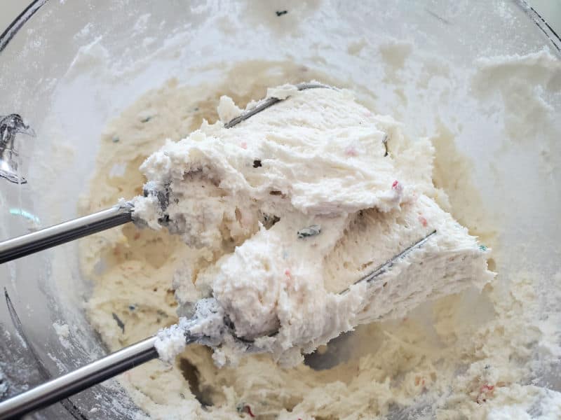 mixer beaters in a glass bowl mixing batter