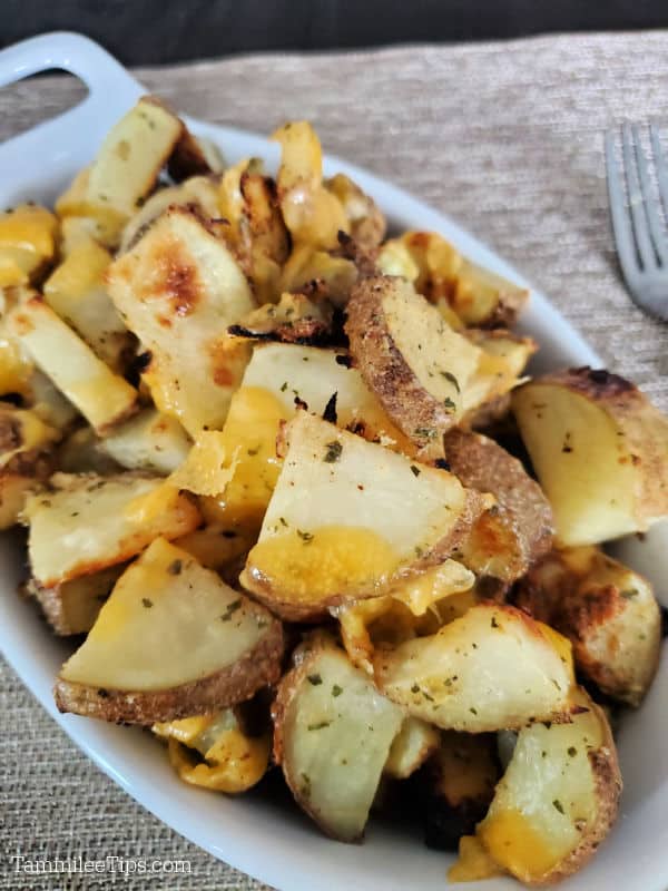 Hidden Valley Ranch Potatoes in a white baking dish with a fork next to them. 