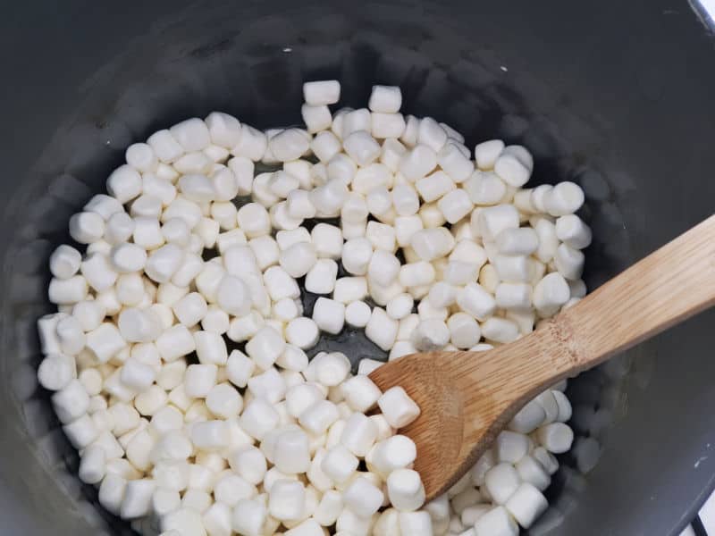 marshmallows in a pot with a wooden spoon