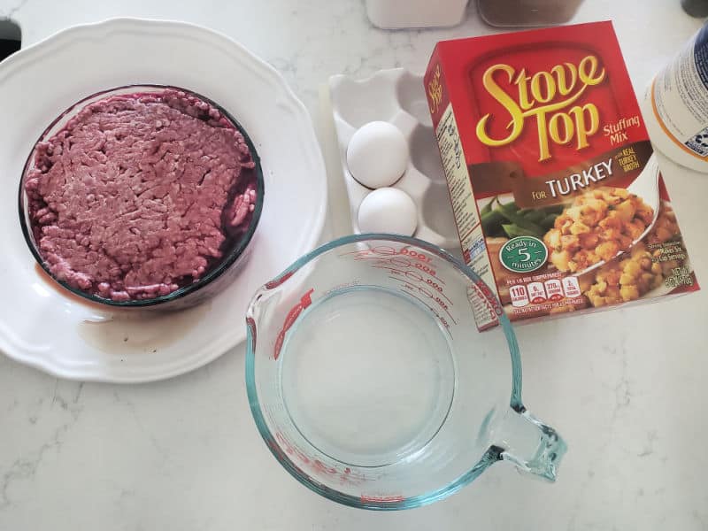 ground beef, eggs, water in a measuring glass, and stove top stuffing. 