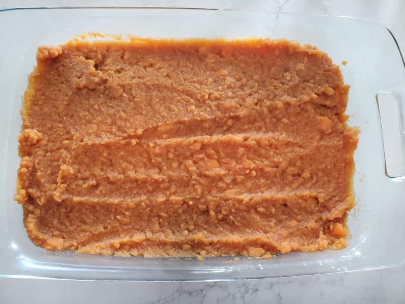 mashed sweet potatoes spread in a glass casserole dish