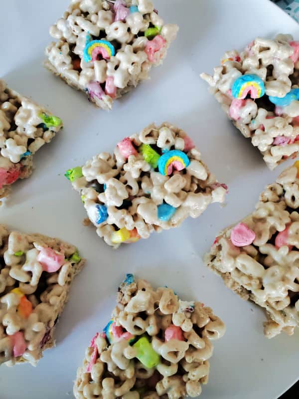 Square lucky charms treats spread on a white plate
