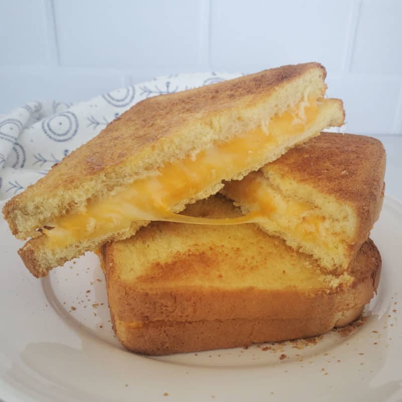 air fried grilled cheese stacked on a white plate