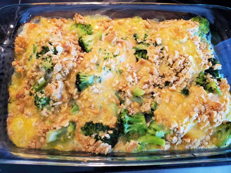 broccoli, cheese sauce, and ritz crackers baked in a glass baking dish. 