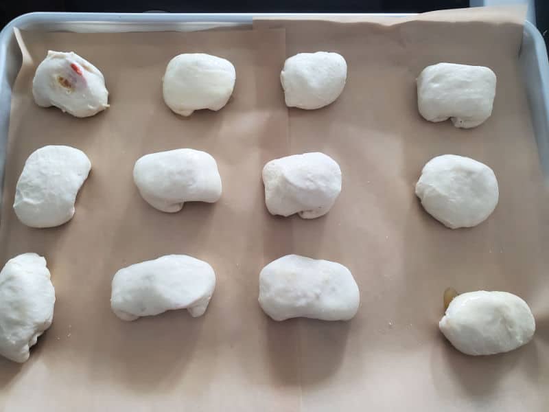 pepperoni ball dough lined on a parchment lined baking sheet. 