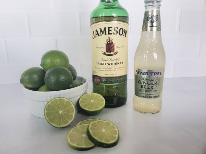 Irish Mule ingredients, Jameson Irish whiskey, fever tree ginger beer, and limes