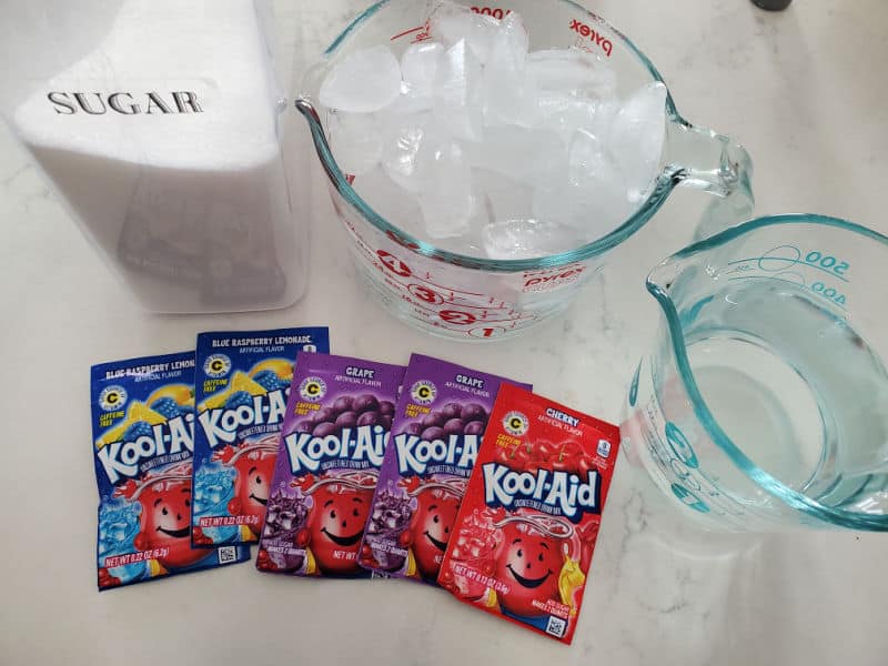 sugar, ice, and water next to kool aid packages. 