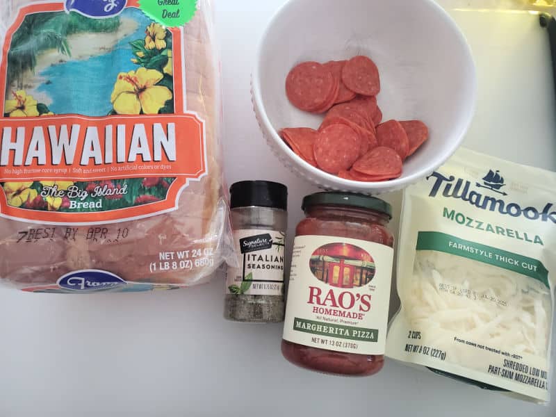 Hawaiian bread, pepperoni in a white bowl, Italian seasoning, Rao's margherita pizza sauce, and Tillamook mozzarella 