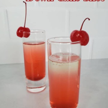 Pineapple Upside Down Cake Shot text over a pink layered shot with maraschino cherry