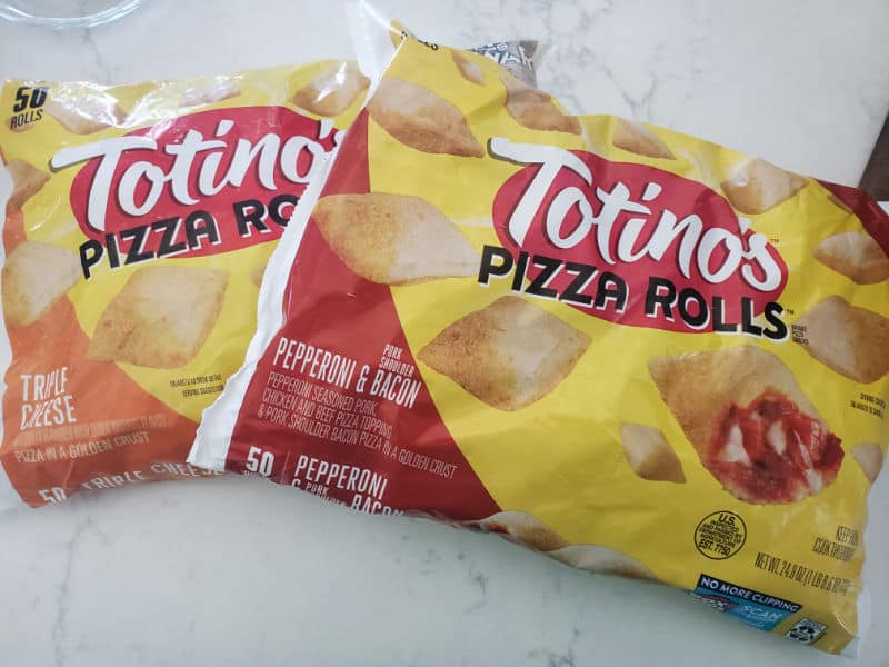 2 bags of Totino's pizza rolls on a white counter