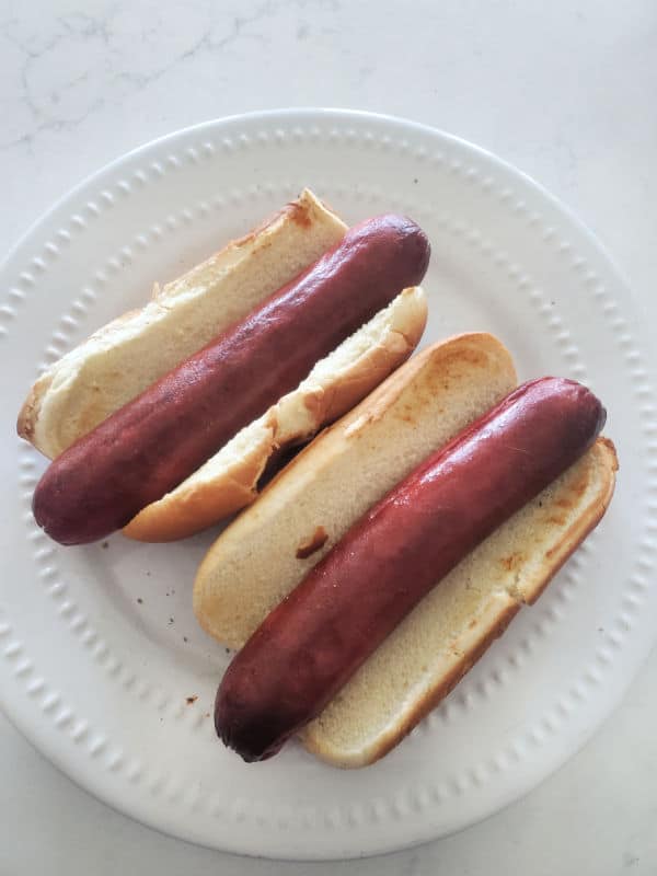 air fried hot dogs on toasted buns on a white plate