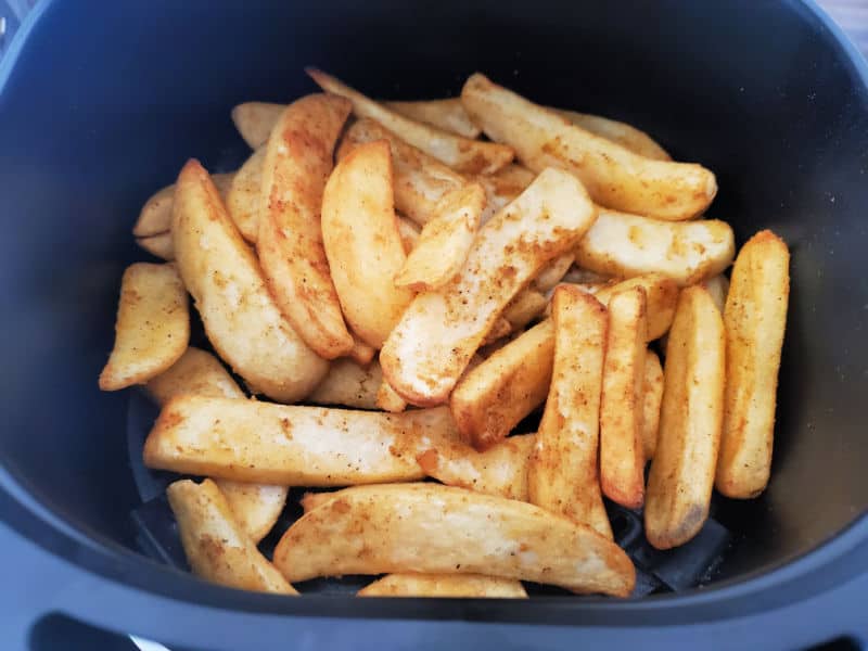 Air fryer French fries in the air fryer basket. 