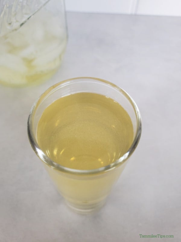 Close up of the top of a Green Tea Shot in a clear glass shot glass. 