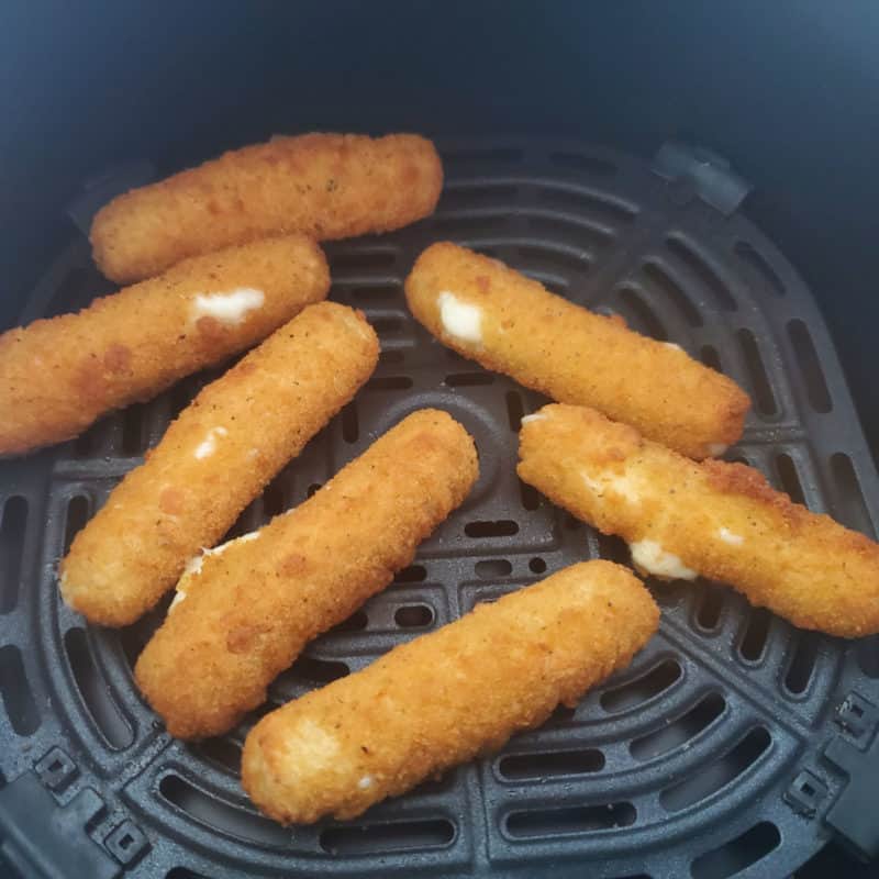 Air fried mozzarella sticks in the air fryer basket